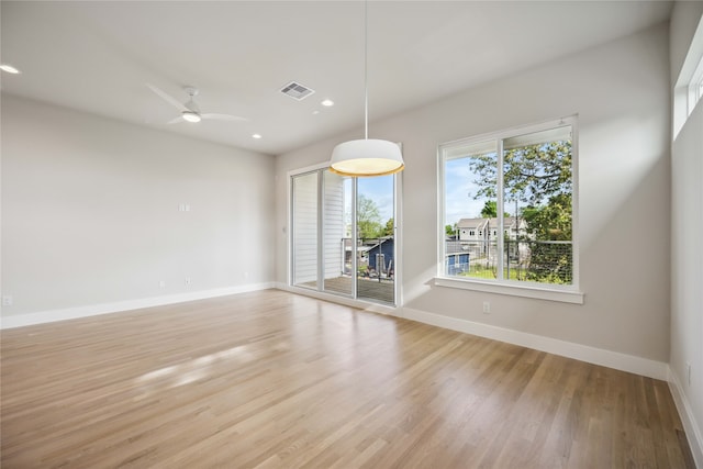 spare room featuring light hardwood / wood-style flooring and ceiling fan