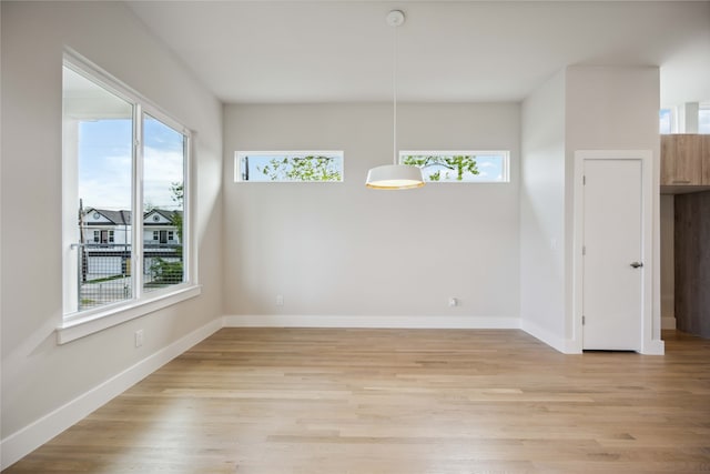 unfurnished dining area featuring light hardwood / wood-style flooring and a wealth of natural light