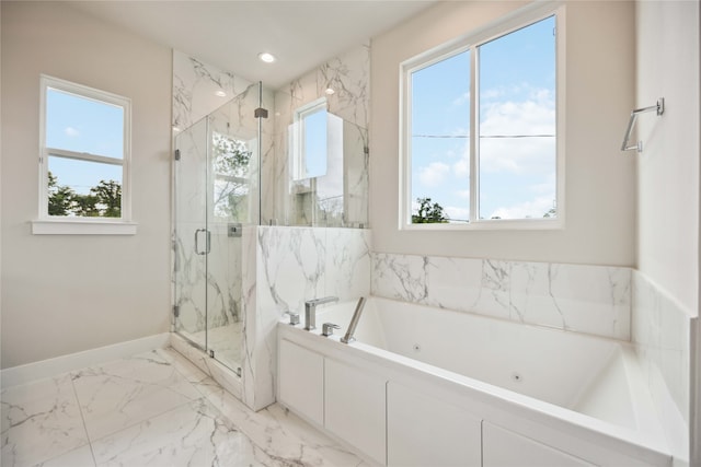 bathroom with a healthy amount of sunlight and separate shower and tub