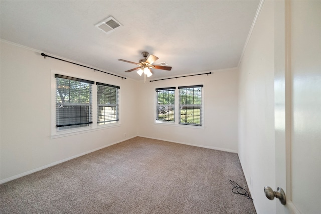 carpeted empty room with crown molding and ceiling fan