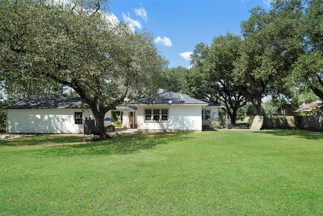 rear view of property featuring a yard