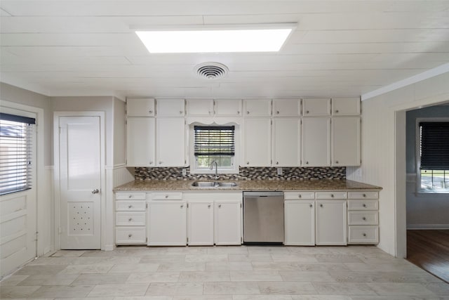 kitchen with white cabinets, dishwasher, backsplash, and a wealth of natural light