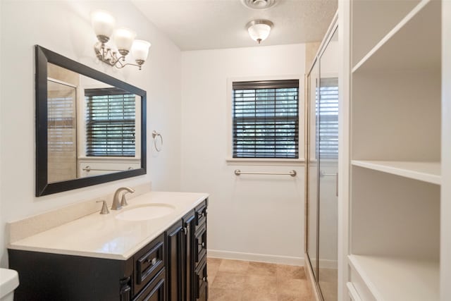 bathroom with vanity, tile patterned flooring, a textured ceiling, a shower with shower door, and toilet