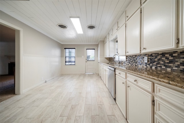 kitchen featuring white cabinets, sink, light hardwood / wood-style flooring, stone countertops, and dishwasher