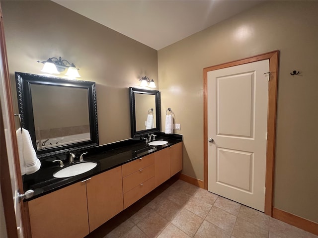 bathroom featuring tile patterned floors, a tub to relax in, and vanity