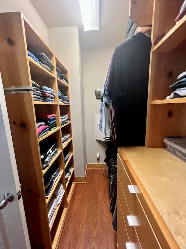 spacious closet featuring light hardwood / wood-style flooring