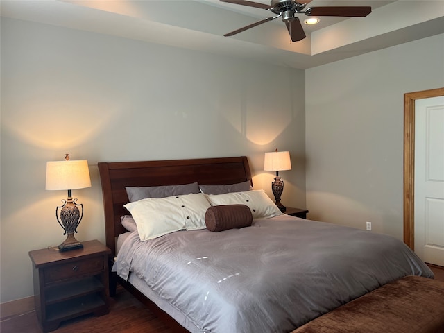 bedroom with dark wood-type flooring and ceiling fan