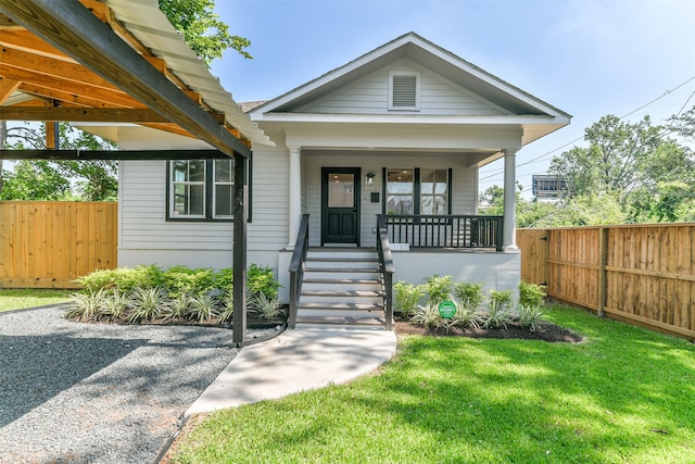 bungalow featuring a porch and a front lawn