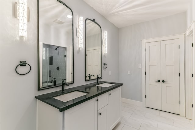 bathroom featuring tile patterned floors, walk in shower, and vanity