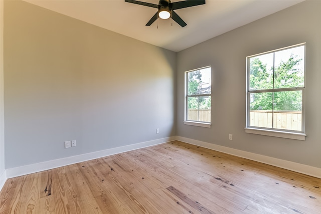 unfurnished room with light hardwood / wood-style floors, a wealth of natural light, and ceiling fan