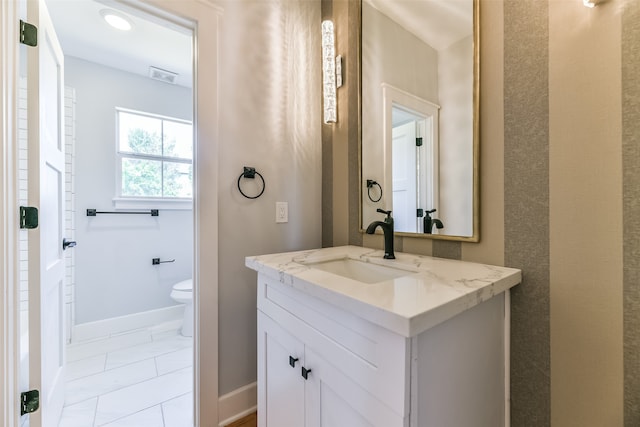 bathroom with vanity, tile patterned flooring, and toilet