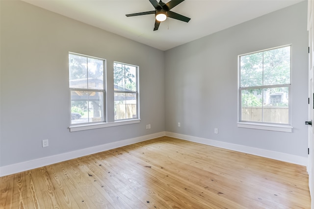 empty room featuring light wood-type flooring and ceiling fan