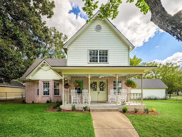 view of front of home featuring covered porch and a front lawn