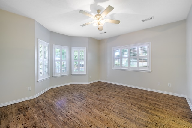 spare room with ceiling fan, dark hardwood / wood-style flooring, and a wealth of natural light