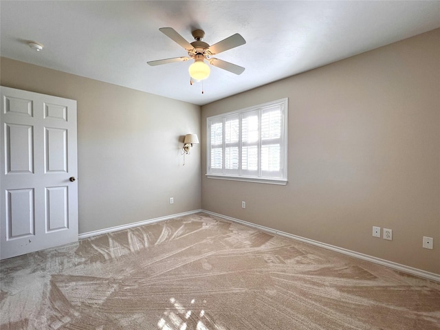 carpeted empty room with ceiling fan