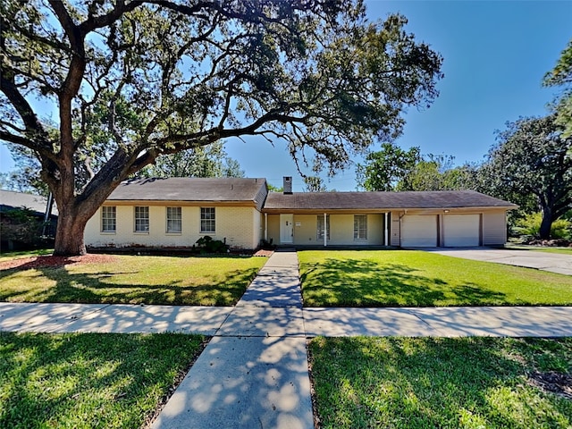 single story home with a front yard and a garage