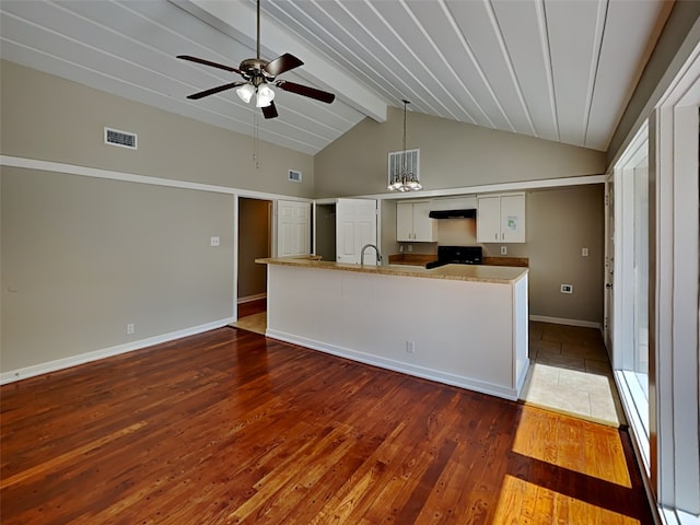 kitchen with black range, pendant lighting, dark wood-type flooring, vaulted ceiling with beams, and white cabinetry