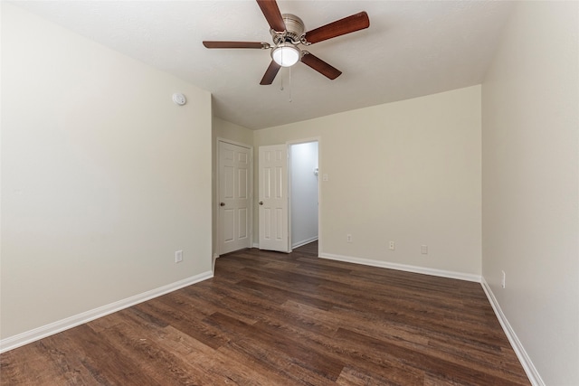 unfurnished room featuring ceiling fan and dark hardwood / wood-style flooring