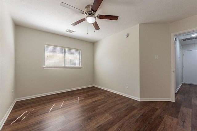 unfurnished room with dark hardwood / wood-style floors and ceiling fan