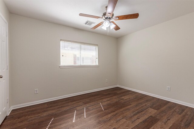 spare room with dark hardwood / wood-style flooring and ceiling fan