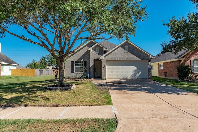 view of front of property with a garage and a front lawn