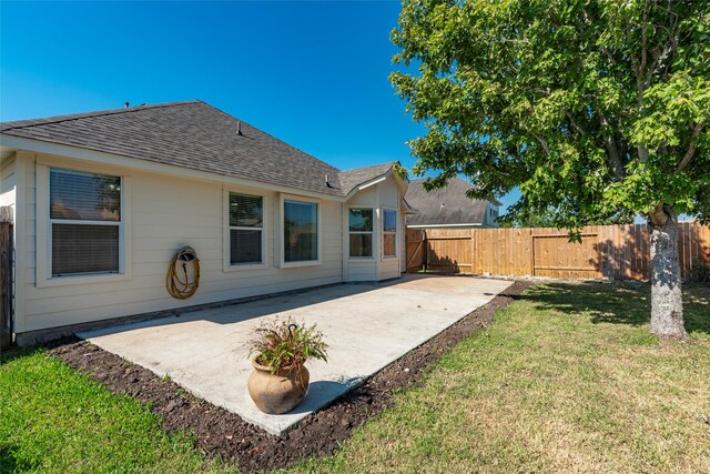 back of property featuring a patio area and a yard