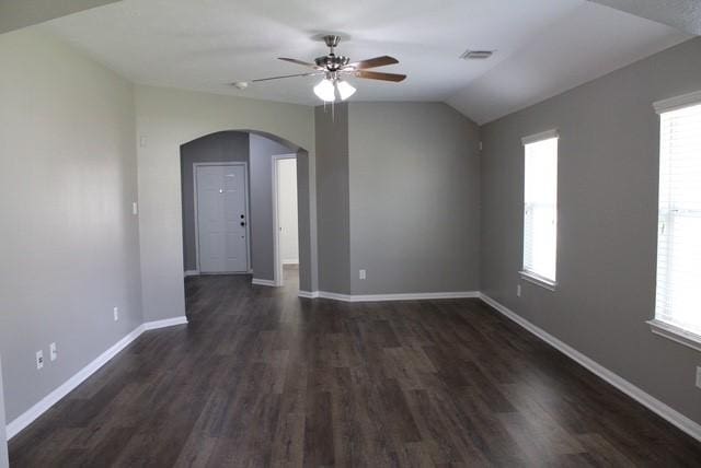 unfurnished room featuring dark wood-type flooring, ceiling fan, and vaulted ceiling