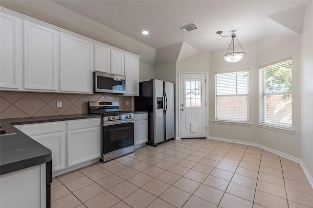 kitchen with decorative light fixtures, decorative backsplash, white cabinets, and appliances with stainless steel finishes