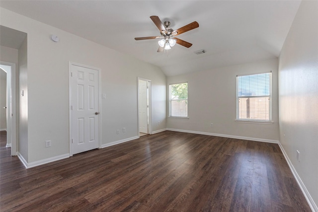 empty room with lofted ceiling, dark hardwood / wood-style floors, and ceiling fan