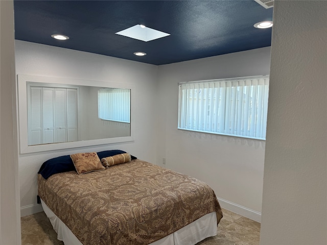 bedroom with a skylight and multiple windows