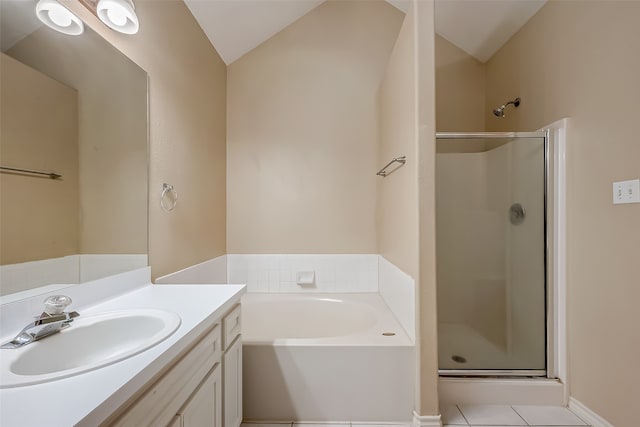 bathroom with vanity, tile patterned floors, vaulted ceiling, and separate shower and tub