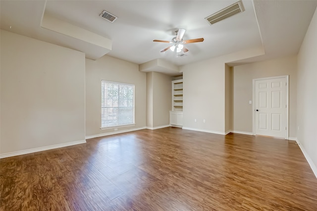 spare room with dark wood-type flooring and ceiling fan