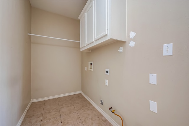 laundry room with cabinets, gas dryer hookup, hookup for a washing machine, light tile patterned flooring, and electric dryer hookup