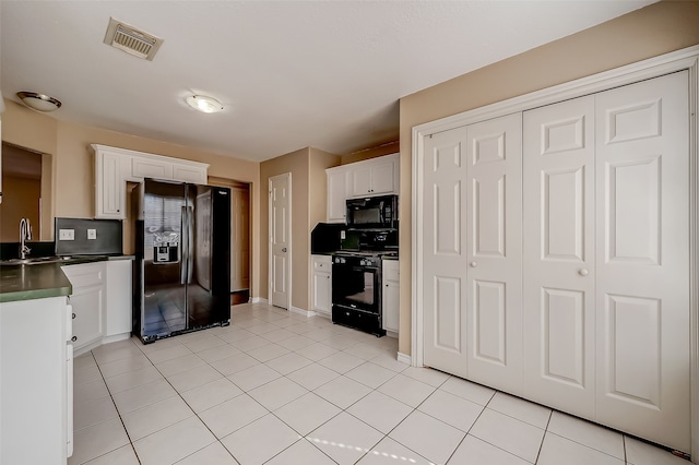 kitchen featuring black appliances, white cabinets, and light tile patterned flooring