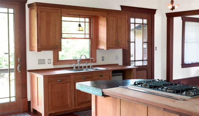 kitchen featuring sink, stainless steel gas stovetop, and wood counters