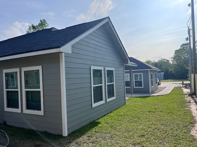 view of property exterior featuring a lawn