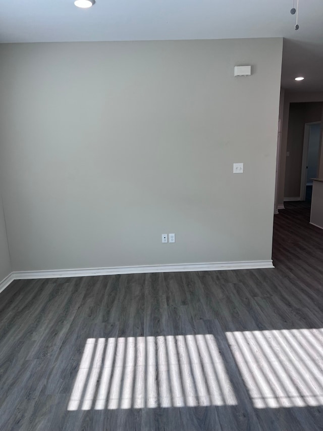 empty room with dark wood-type flooring