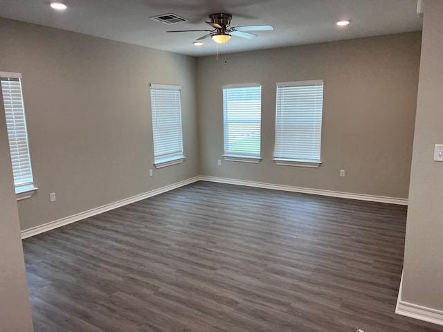 spare room with dark hardwood / wood-style flooring and ceiling fan