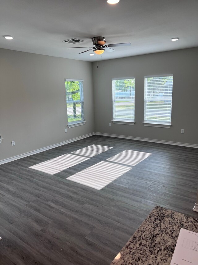 spare room with ceiling fan and dark hardwood / wood-style floors