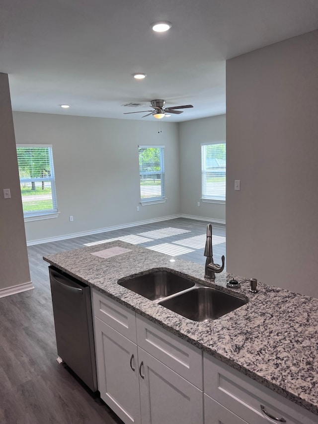 kitchen featuring stainless steel dishwasher, white cabinetry, sink, and plenty of natural light