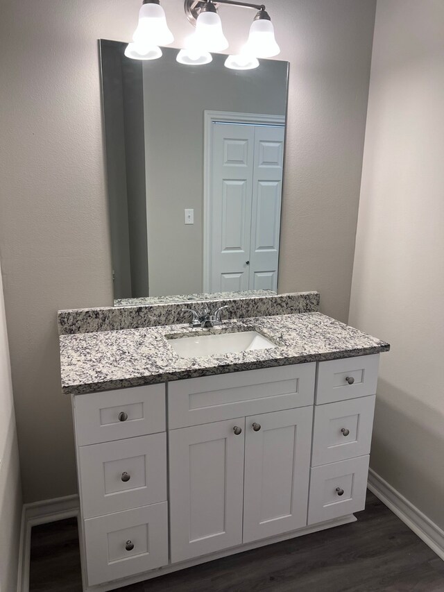 bathroom with hardwood / wood-style floors and vanity