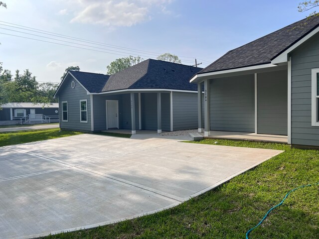 back of house with a lawn