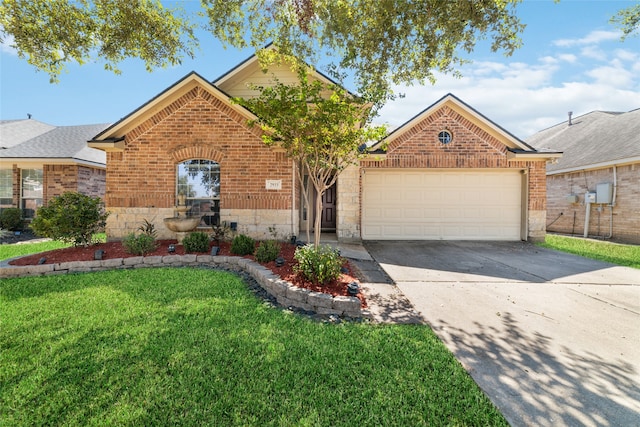 view of front of home with a front yard and a garage