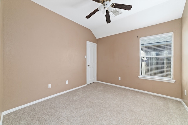 carpeted empty room with ceiling fan and vaulted ceiling