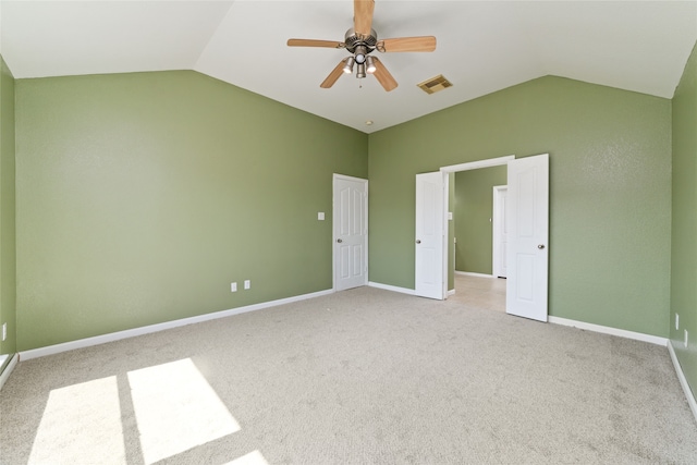 unfurnished bedroom with light carpet, vaulted ceiling, and ceiling fan