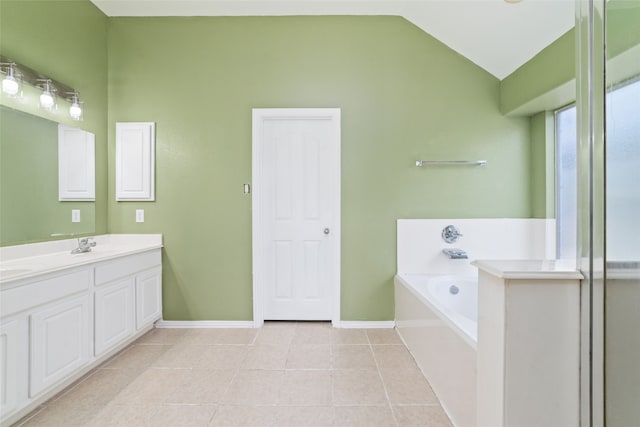 bathroom with lofted ceiling, tile patterned floors, vanity, and a bath