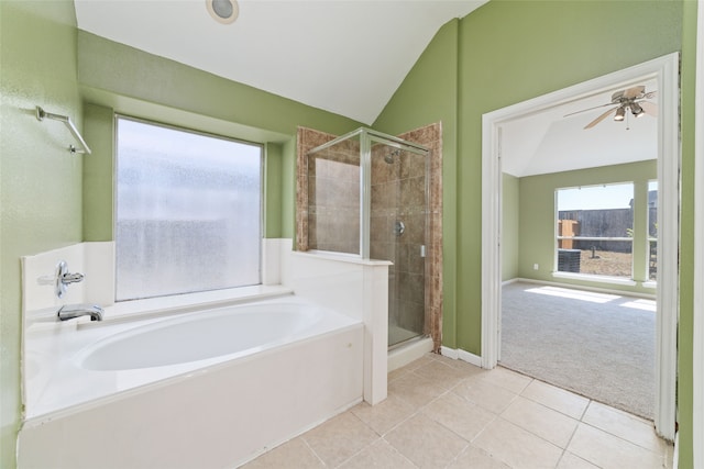 bathroom featuring lofted ceiling, shower with separate bathtub, and a healthy amount of sunlight