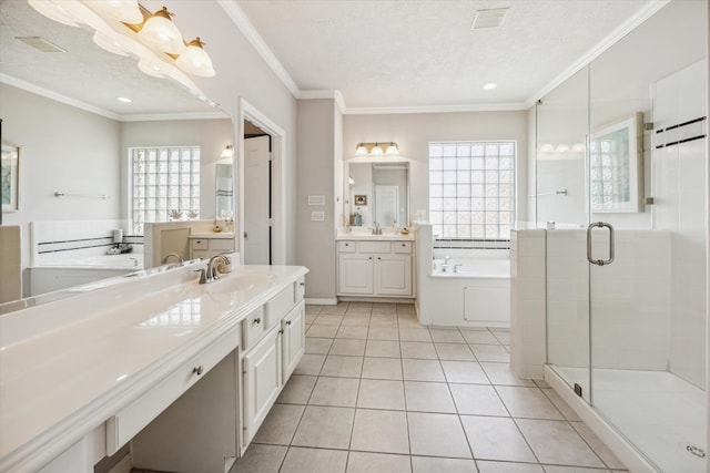 bathroom featuring tile patterned flooring, a textured ceiling, a wealth of natural light, and ornamental molding