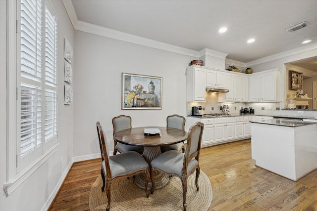 kitchen with white cabinetry, a healthy amount of sunlight, and light wood-type flooring