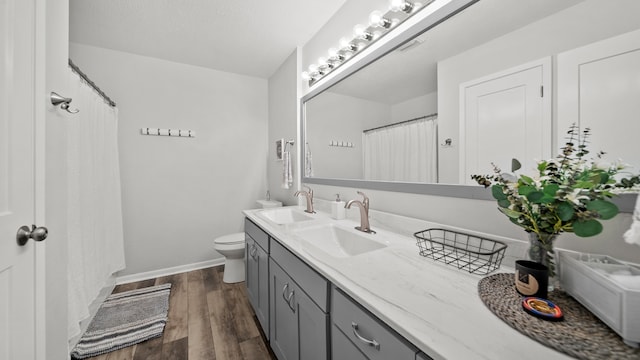 bathroom featuring vanity, a shower with shower curtain, wood-type flooring, and toilet